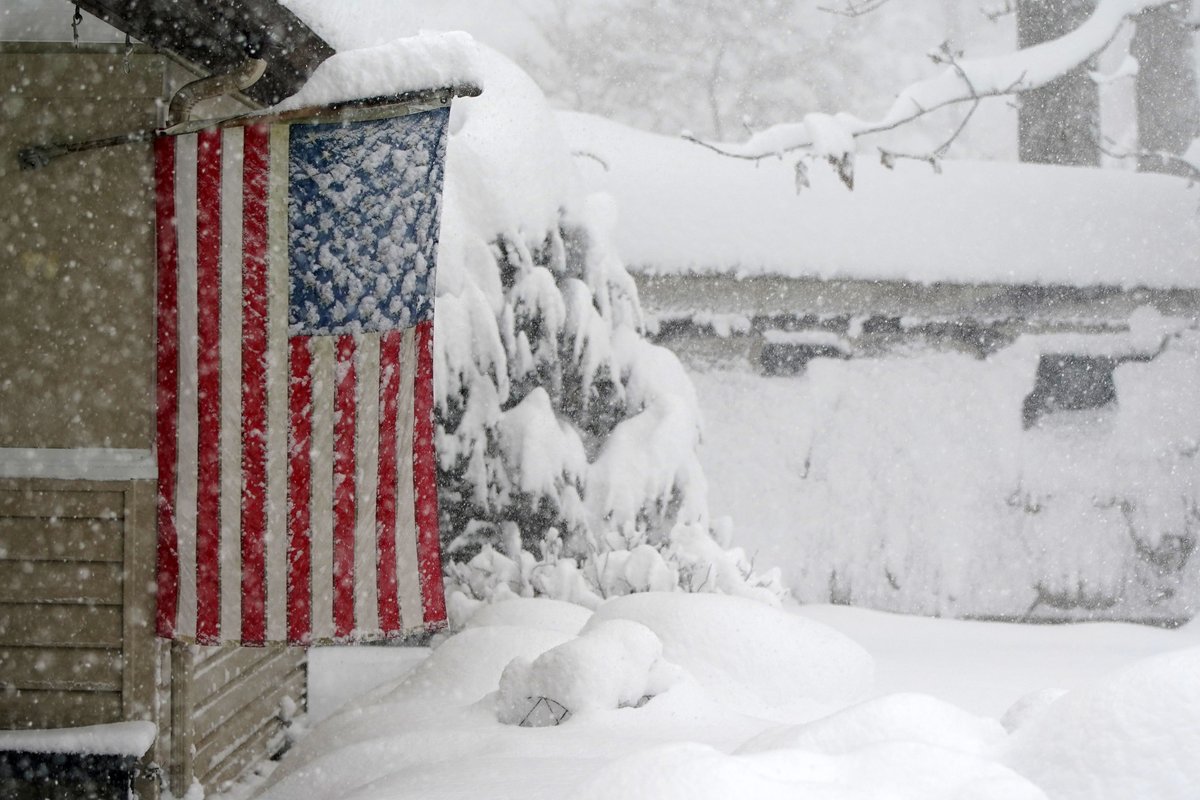 Snow covers the stars on an American flag at a home in Orchard Park Friday, November 18, 2022.      (Mark Mulville/Buffalo News) #buffalosnow