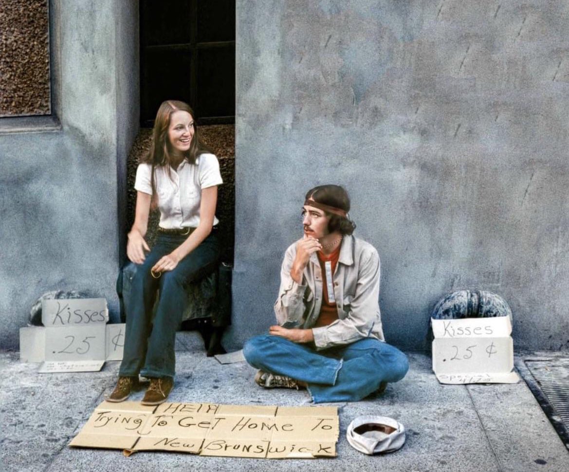 50YearsAgoLive's tweet image. A couple hitchhiking from Vancouver, British Columbia to New Brunswick, all the way across Canada. The couple are offering kisses for 25 cents.
