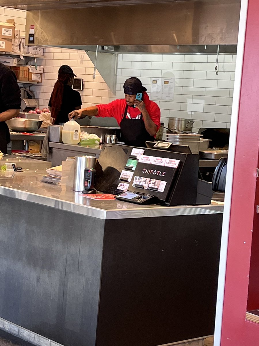 Bobakanoah's tweet photo. @ChipotleTweets What are your standards about employee phone use while cooking? One worker with food service gloves on is using her phone, and the cook is talking on his phone at your store on Two Notch Rd in Columbia, SC. https://t.co/ij1YBOU8Cf