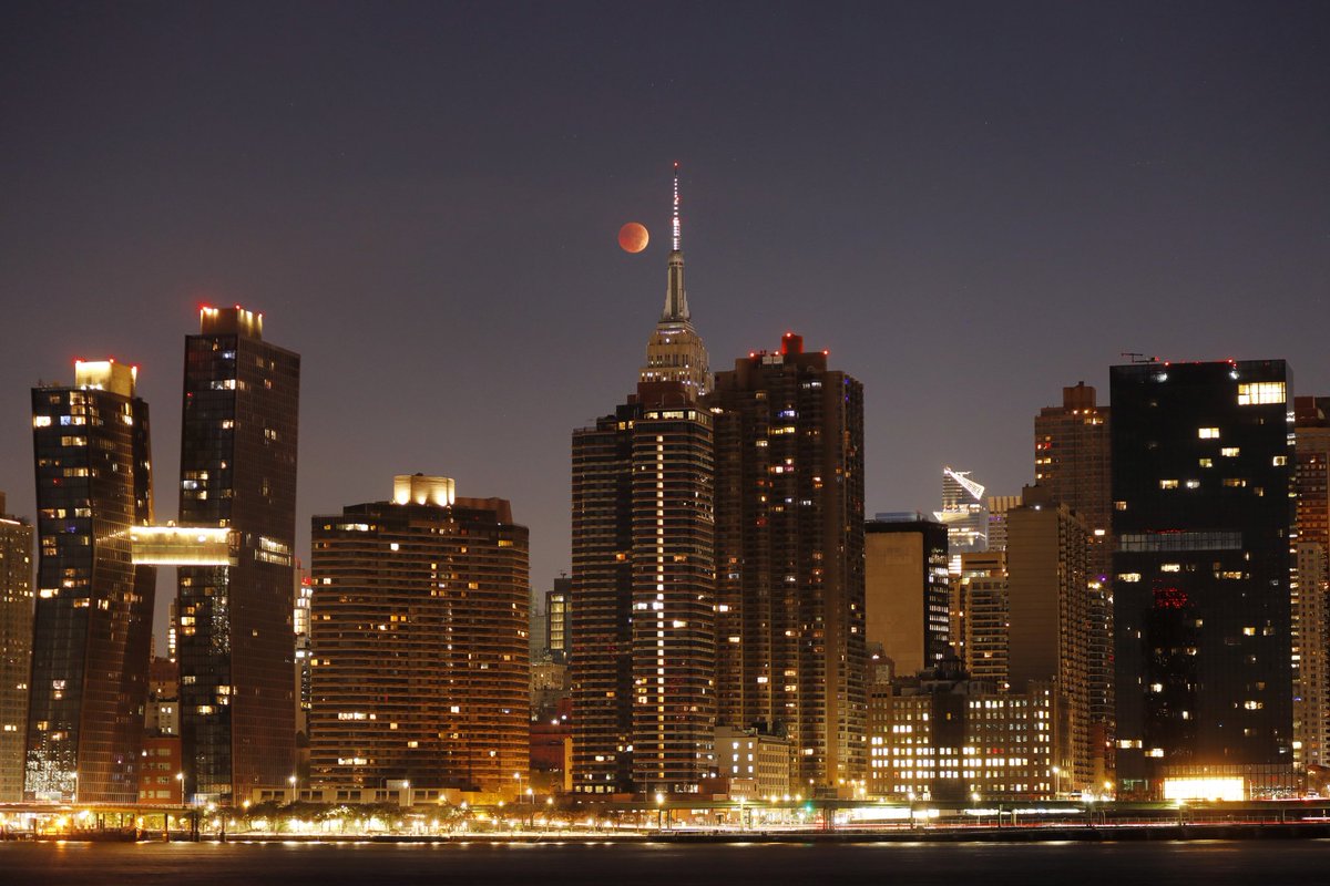 The totally eclipsed blood red moon passes behind the Empire State Building in New York City, Tuesday morning in New York City #BloodMoon #LunarEclipse #beavermoon #newyork #newyorkcity #nyc <a href="/EmpireStateBldg/">Empire State Building</a>