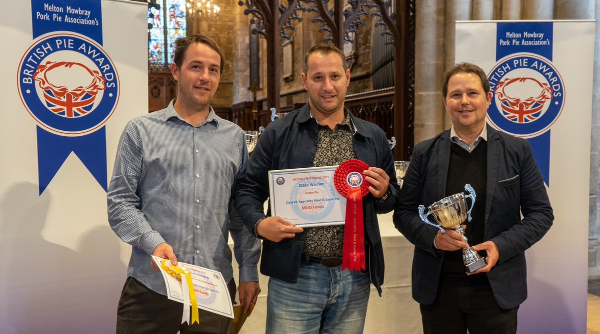mudfoods's tweet photo. Christian and Nik, Mud's Team Leader, accept the Class Champion trophy for our Game Pie at the British Pie Awards last year. To try one visit https://t.co/JGBtE29iBc and get our offer: £3.99 on all game and venison pies. (photo c/o Martin Elliot at mepics) #gamepie #venisonpie https://t.co/hCsuQX2UGX