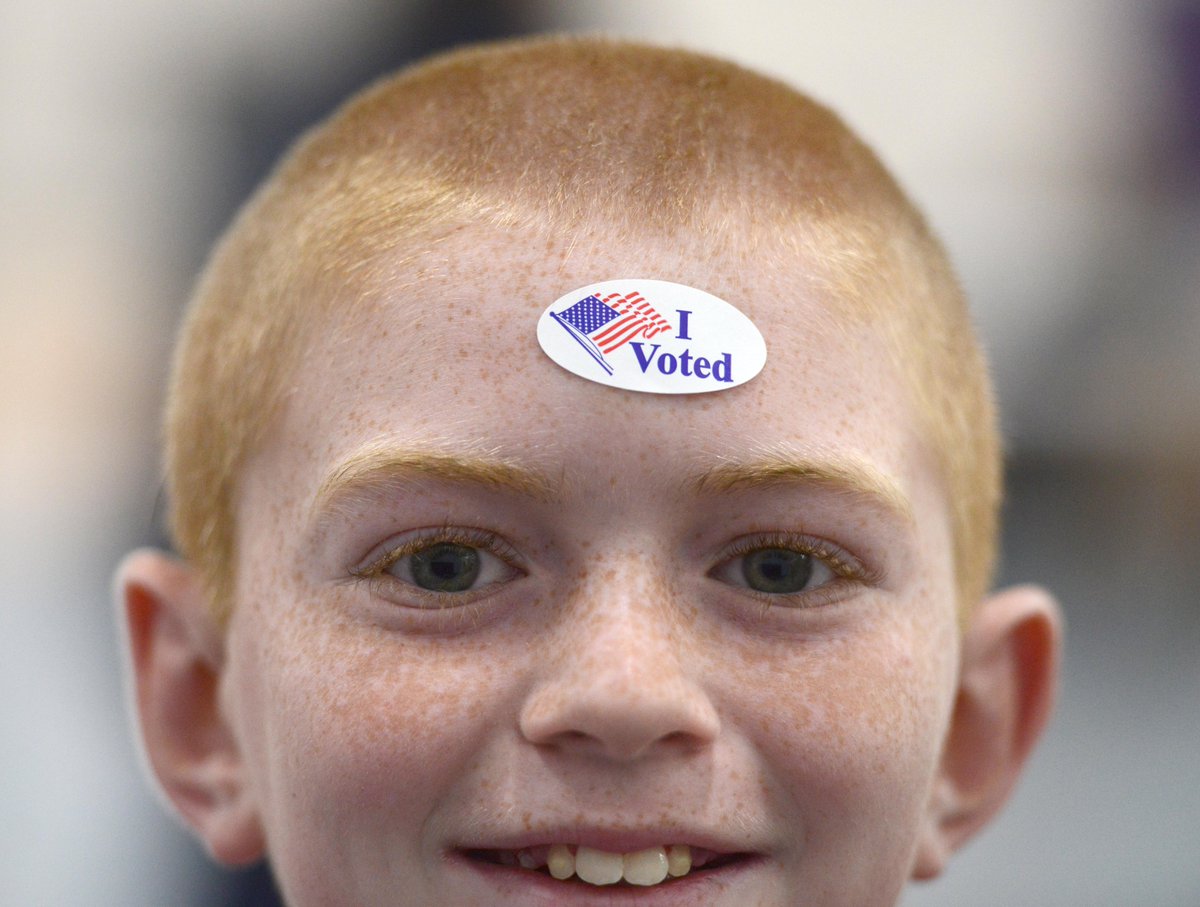 Ten year old Logan Desrosiers proudly sports his mom Kristina's voting sticker as he and his brother Cody joined her at the Bourne Community Center where the town's precinct 1, 2, and 3 voters cast their ballots on election day. <a href="/capecodtimes/">Cape Cod Times</a>