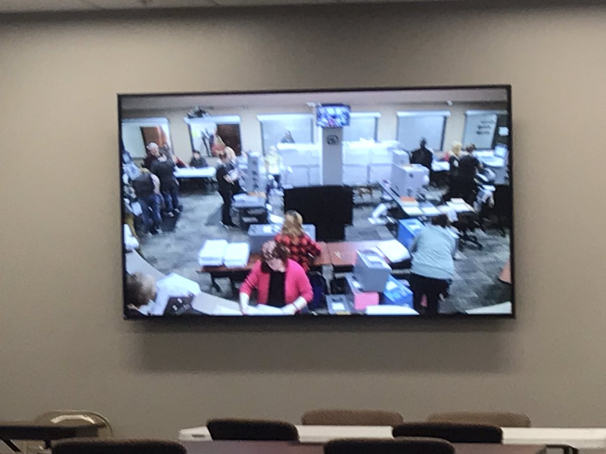 A wall-mounted, large -screen TV  offers a live look at the vote counting inside the Minnehaha County Commission chamber   #KELONEWS