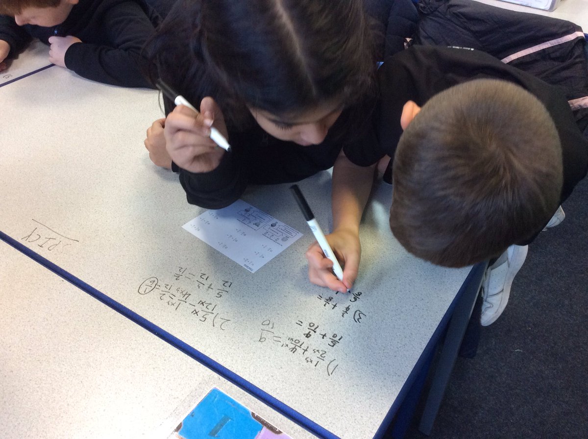 Vernon56KS2's tweet photo. In Mrs Ingram’s maths group, we are adding and subtracting fractions, using the table as our working space! #vppmaths https://t.co/pmhm3jHQAN
