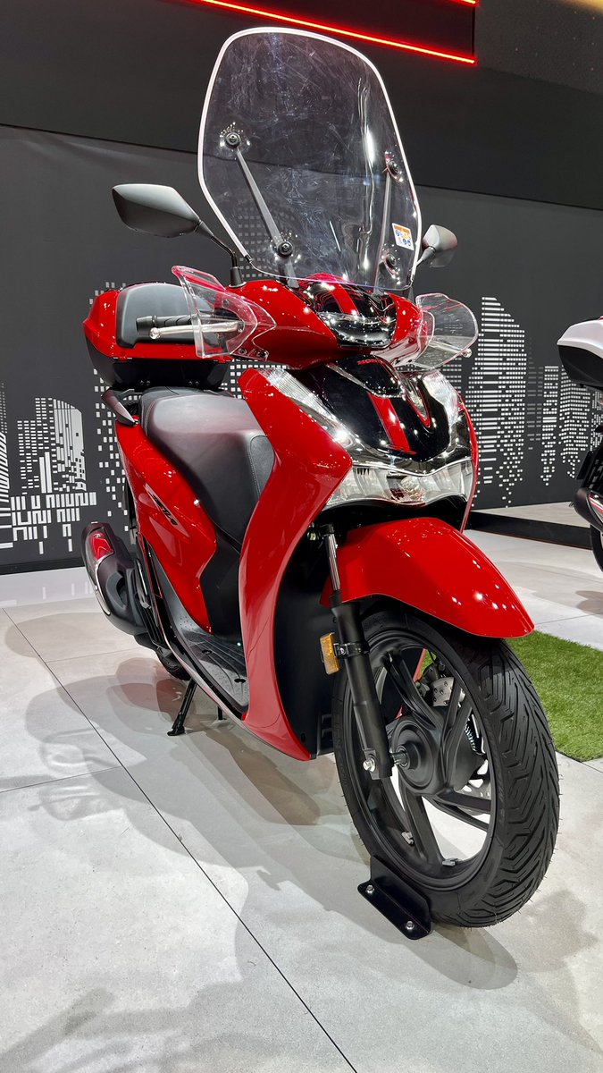 DobleHonda's tweet photo. The home of the scooter is well catered for here in Milan. Honda’s best selling #SH125, #SH150 & #SH350 all stand proud supporting their new livery for 2023.
#DobleMotorcyclesOnTourEicma https://t.co/KHIsFS7rgu