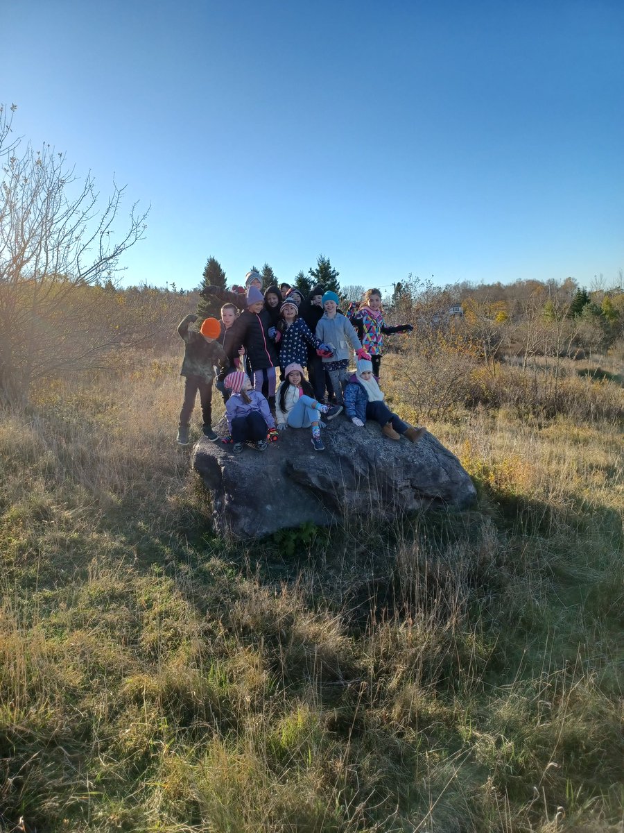 ForestHillsPE's tweet photo. Practicing balancing first thing this morning. We couldn't resist getting a group shot on our famous Forest Hills rock! #outsidePE #PhysEd @ASDS_PhysEd https://t.co/2fXn75SYQI