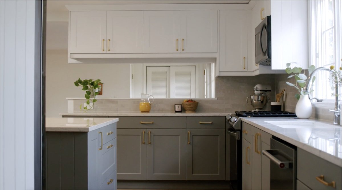 This elegant Shaker Chelsea kitchen in Dove Matte and Pillow Matte shows how two colors can blissfully blend. The sophisticated frontals are enhanced with Quartz Blanca Arabescato countertops and gold handles, creating a timeless look. #wrenovation #wrenkitchens