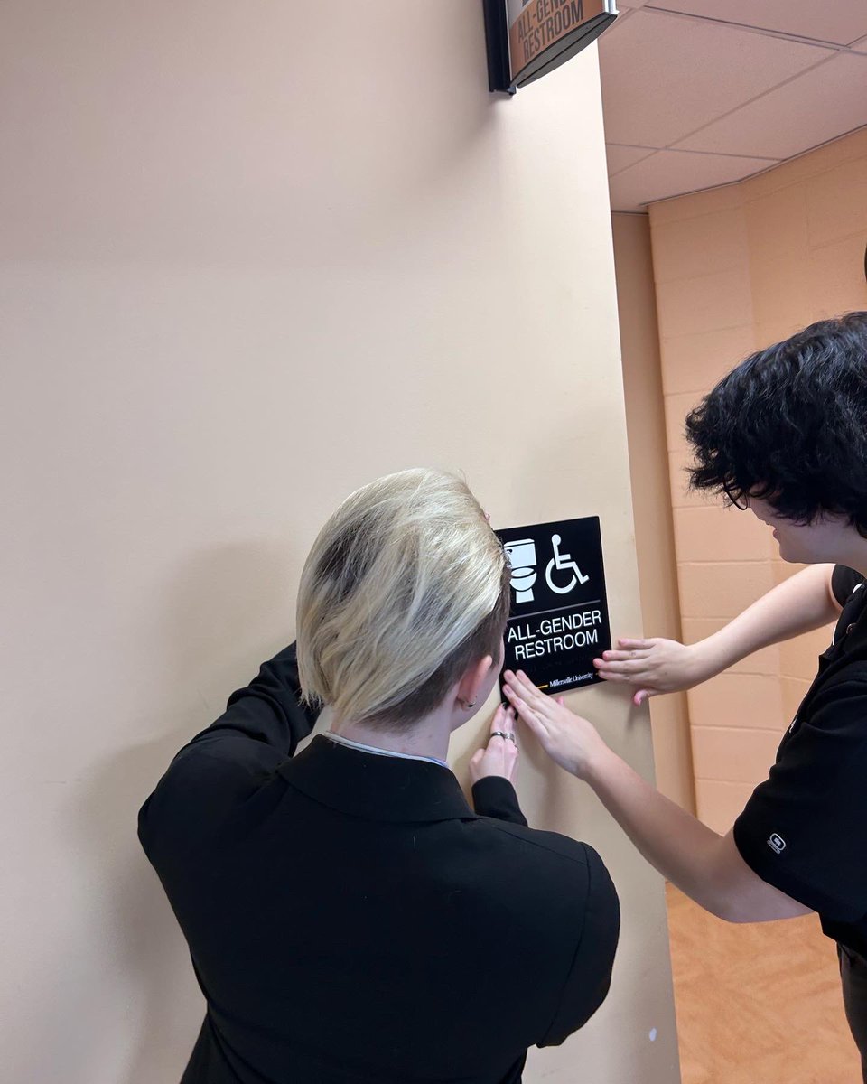 Today, our first gender neutral bathroom has been established! This bathroom is located in the SMC, next to the MPR. A big thank you to Kerri (our DEI rep), SGA President Lindsay, the rest of SGA, and some other friendly faces for being there and making this happen.