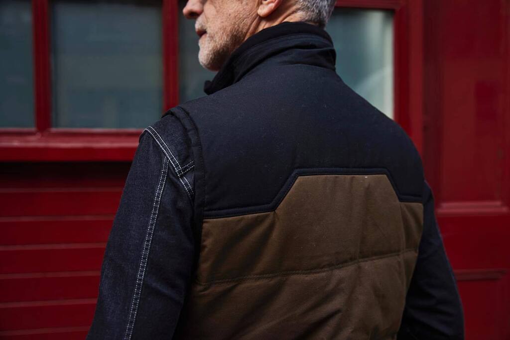 The new Quilted Utility Gilet is what we called it. Part of that Utility is being wearable in all kinds of situations. I find too many body warmers are synthetic and floppy, shiny, sporty. I prefer to make something clean-lined, structured, subtle, masculine, classic… but mo…