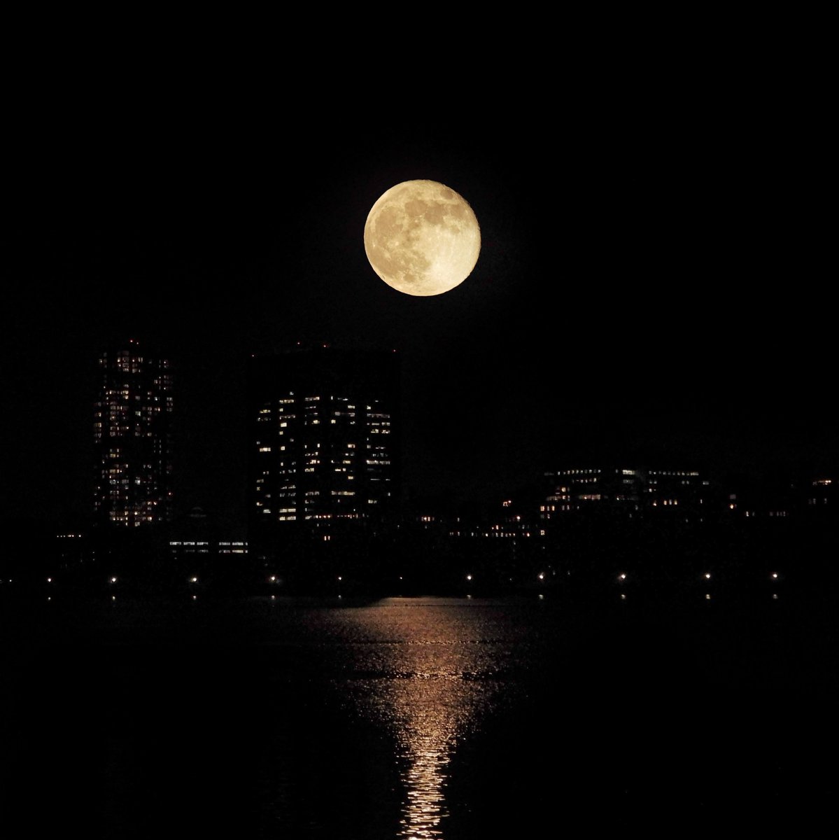 The rising Moon, still nearly full, shined over the Central Park Reservoir this evening.