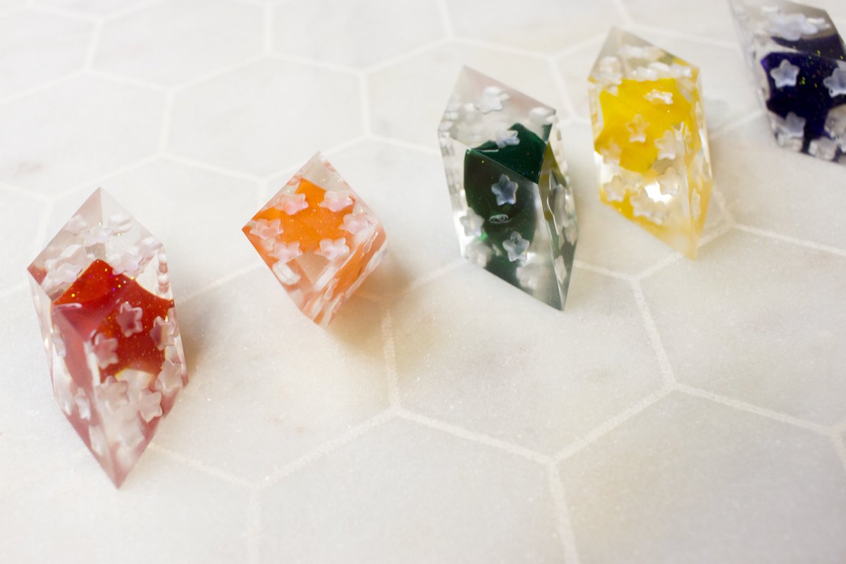 BluAtelier's tweet photo. These pride dice are subtle with each star representing a stripe from the rainbow flag. Inside each D6 is a lucky origami star for happy days. Both subtle and whimsical I love how they turned out. 

#lgbt #lgbtq #pridedice #handmadedice #dice #dnd5e #ttrpg #tabletopgames #d6 https://t.co/Q0yZCpvN4x