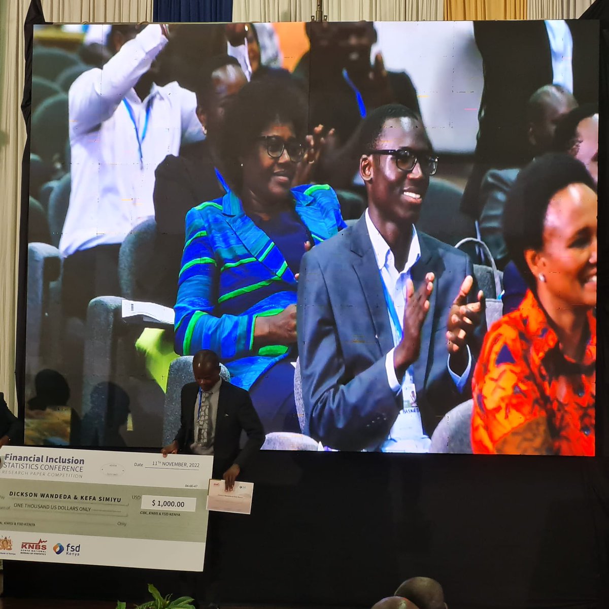 KNBStats's tweet photo. And the winner is...
Congratulations are in order for Dickson Wandeda, PhD and Kefa Simiyu awarded a cheque of  USD 1000 by Prof.Njuguna Ndung'u, CBS, CS National Treasury during Day4 of #FinanciaIinclusionConference @KSMSKenya #FinAccess @FSDKe @CBKKenya https://t.co/jkLYWhPn0z