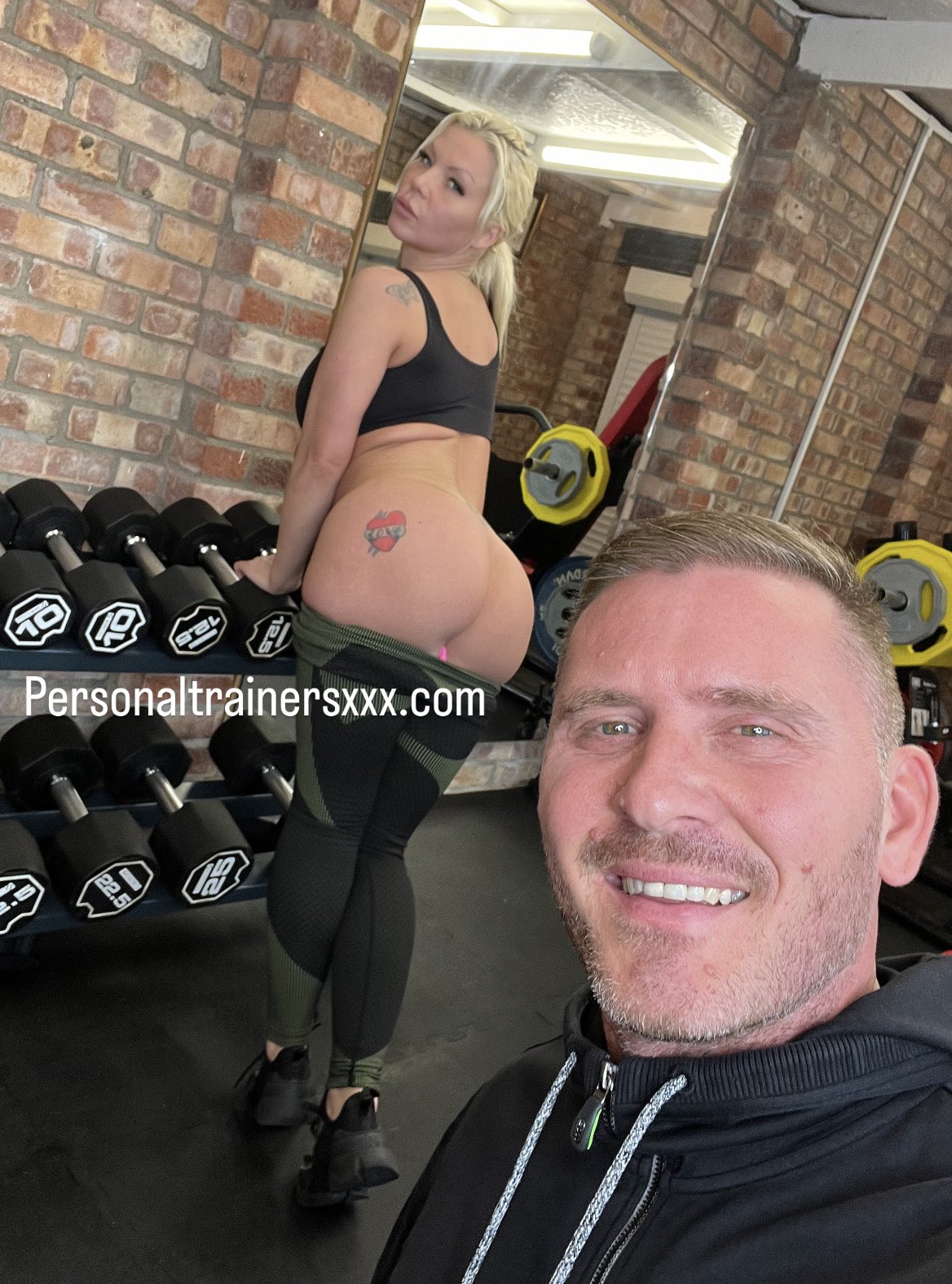 a man and woman embrace intimately on gym equipment