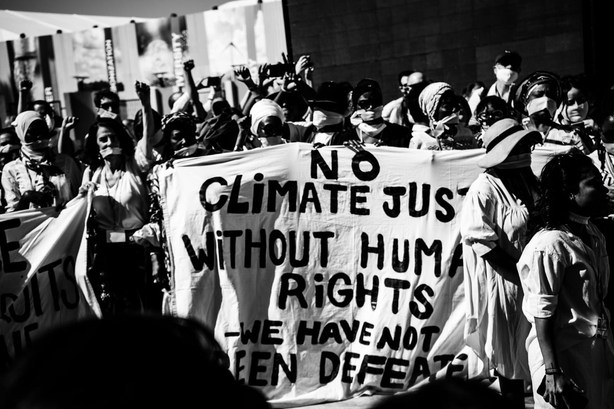 RhodaClimate's tweet photo. We are not yet defeated...the chants are getting louder at #COP27 as activists mobilise against human right abuses in #Egypt. Follow for more on todays protests. https://t.co/WeE6s84yJs