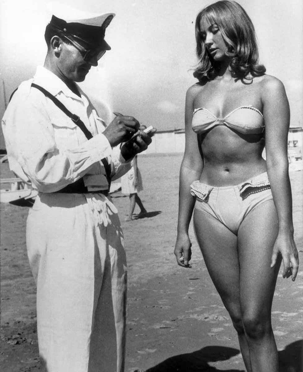 historyinmemes's tweet image. A police officer issuing a woman a ticket for wearing a bikini on an Italian beach, 1957. At the time the bikini was banned from beaches and public places on the French Atlantic coastline, Spain, Italy and Portugal.