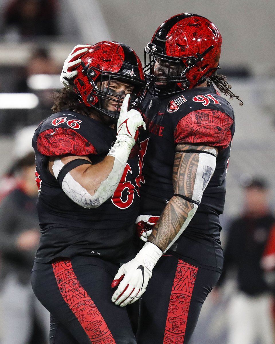 MegMcLaughlinDA's tweet photo. San Diego State defensive linemen and brothers Jonah Tavai (66) and  Justus Tavai (91) celebrate after sacking San Jose State quarterback Chevan Cordeiro (2) during their game at Snapdragon Stadium on Saturday, Nov. 12, 2022 in San Diego, CA. @sdut https://t.co/XvDYarILvr