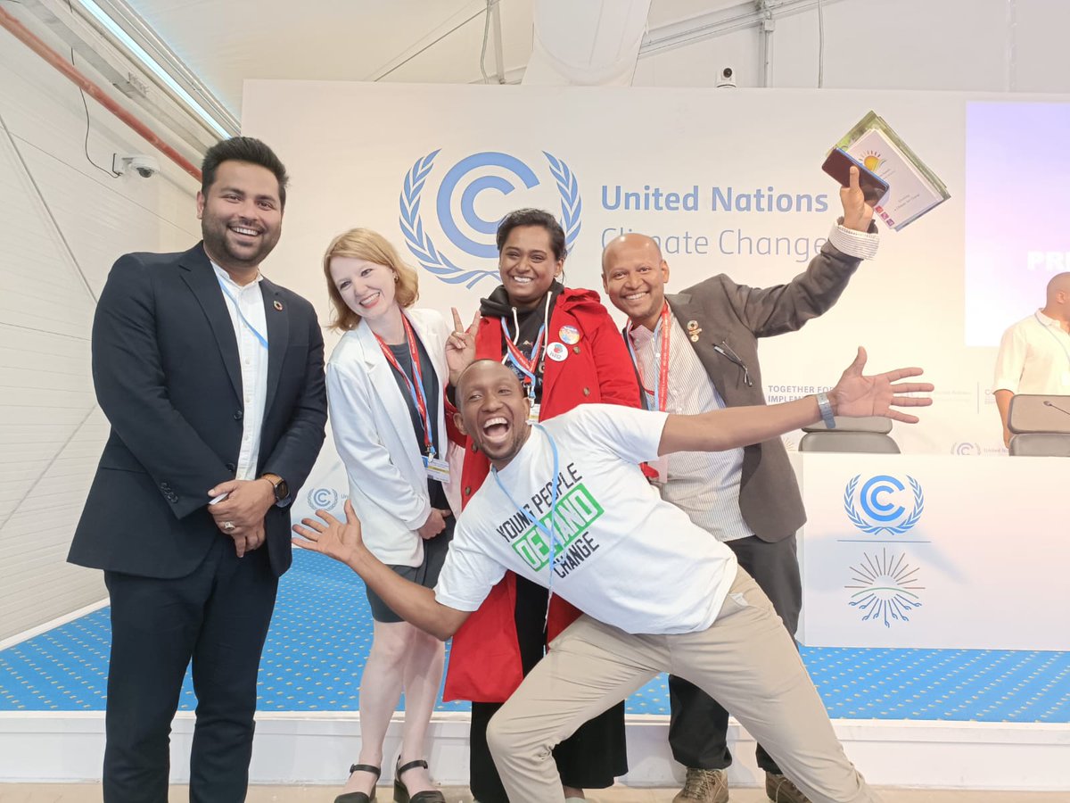 CYNESA's tweet photo. If happiness was "#YoungPeopleDemandingChange" then this would best define it. @davemunene posing with stakeholders after a session @COP27P #SharmAlSheikh. #LossandDamage #LossAndDamageFinance https://t.co/bSCtmyfoEY