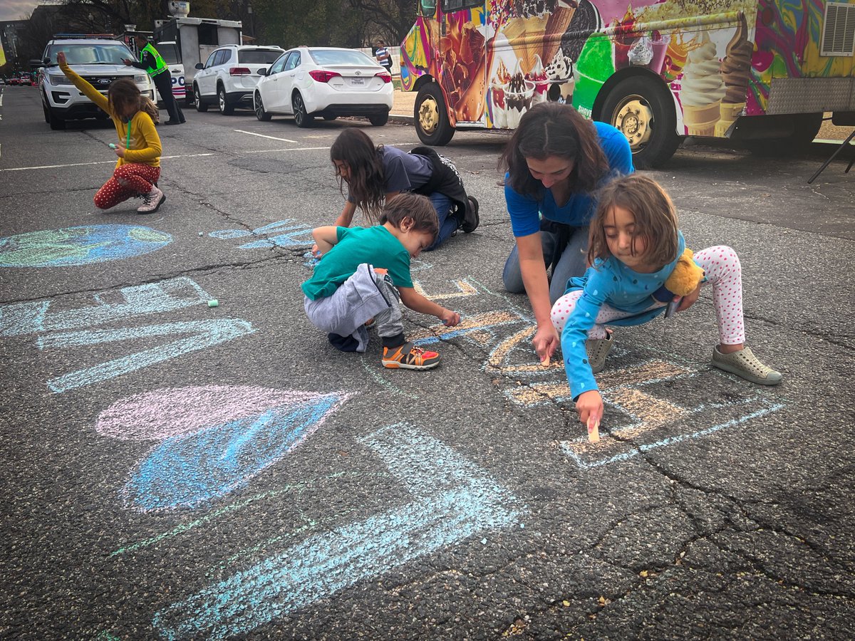 Kids join in on the street art: “Love Earth Hate War”