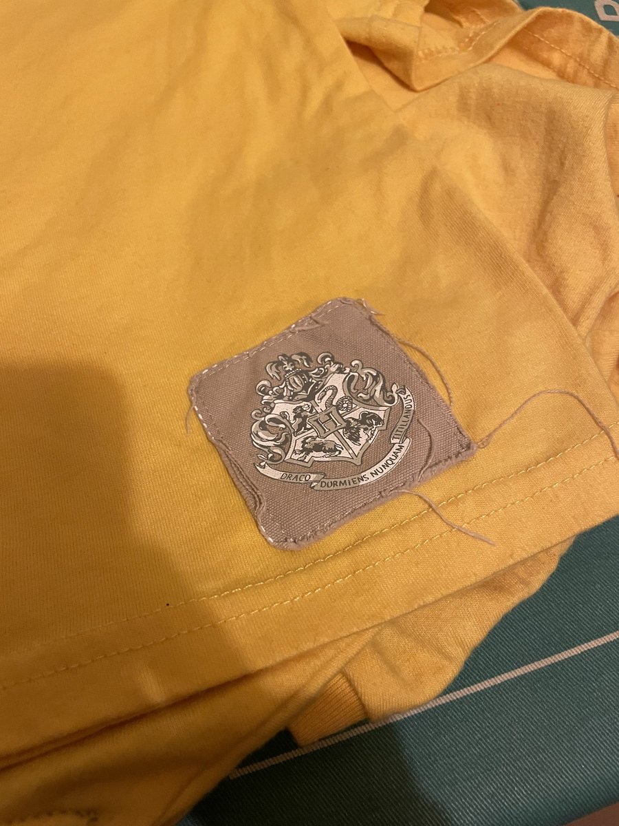 SiwanH's tweet photo. @wizardingworld rather disappointed with my daughter’s Hufflepuff t-shirt. One wash and the label is frayed https://t.co/mppVM9CzJR