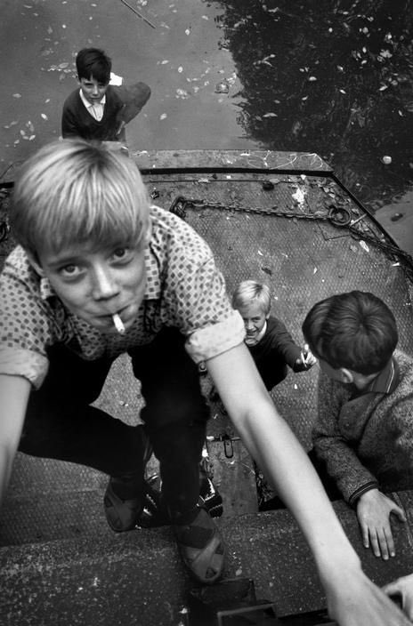 Richard Kalvar - Kids smoking at canal, 1966.