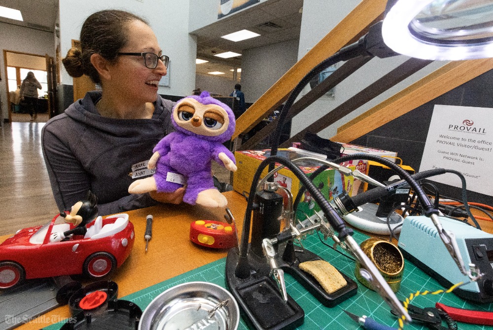 SeaTimesFotoKen's tweet image. Anat Caspi, w/@TaskarCenter, participates in a “holiday hack” of toys at @PROVAIL_WA, supporting people w/ disabilities Sunday in Seattle. About 35 volunteers rewire toys to make electronics more accessible for kids and others w/disabilities including switches. via @seattletimes