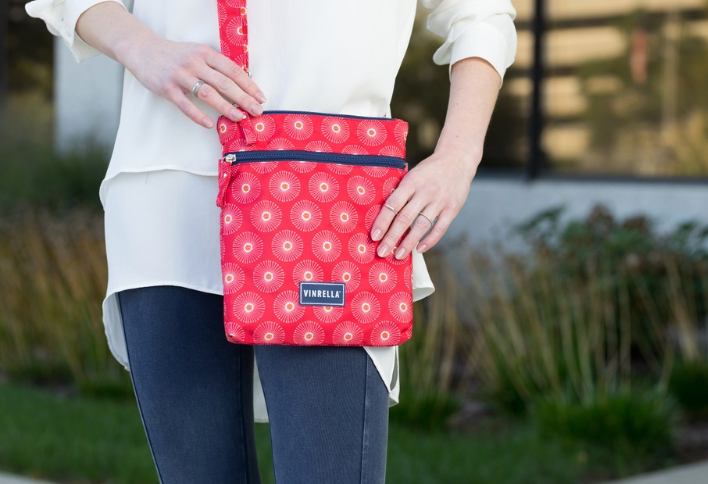 Vinrella's tweet photo. Travel hands-free while still carrying everything you need in the Vinrella crossbody bag. The red Flora design gives your outfit the pop of color you need! Our crossbody bags have a silky smooth water-resistant fabric and front &amp; back compartments for essential items. #crossbody https://t.co/biu25B8JNT