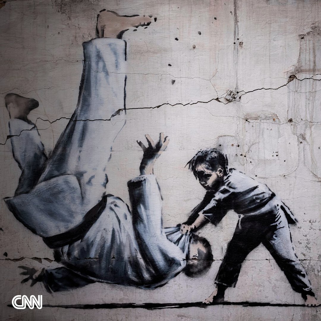 CNN's tweet photo. Three days after Banksy debuted his latest mural on Instagram, spray painted on the wall of a bombed building in the city of Borodianka, Ukraine, the anonymous street artist confirmed that he completed seven new works in Ukraine in total https://t.co/HyaGCPmWqP https://t.co/4Ssudpoajy