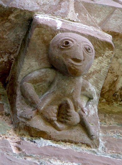 a sheela na gig, a medieval carving of a woman displaying an exaggerated vagina, often used to decorate cathedrals and castles in western and central europe
