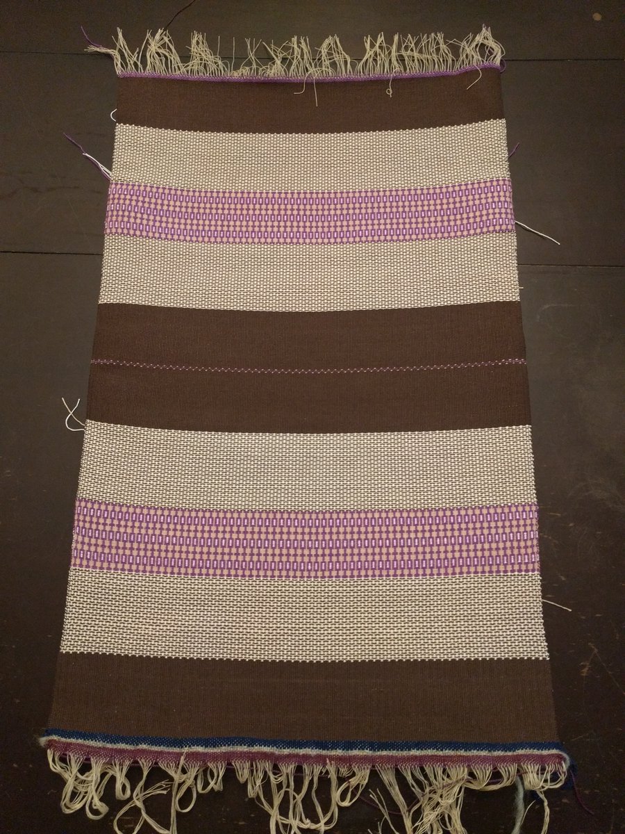 Here is the fabric off the loom. The brown portion in the center will be the bottom of the tote and the tweed-like pattern will be the background along the sides with the purple pattern forming a band around the center. It will be easier to visualize when it is sewn. #weaving