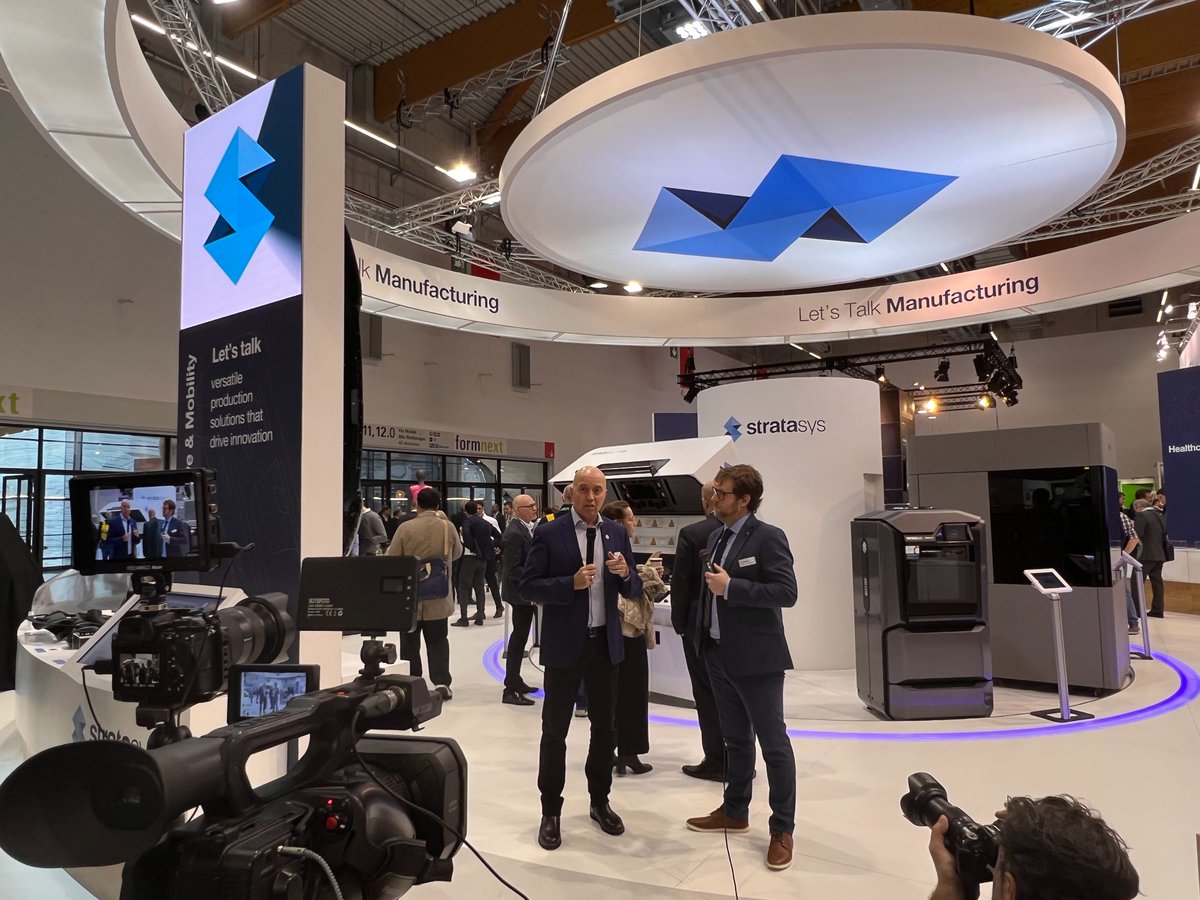 Stratasys's tweet photo. Behind the scenes with Stratasys CEO Dr. @yoav_zeif at #formnext talking about challenges global manufacturers are facing today, the ones #additivemanufacturing can address, with tailored solutions for specific use cases in aerospace, automotive, CPG and beyond. #CreateUnlimited https://t.co/0iVmfRKK4A