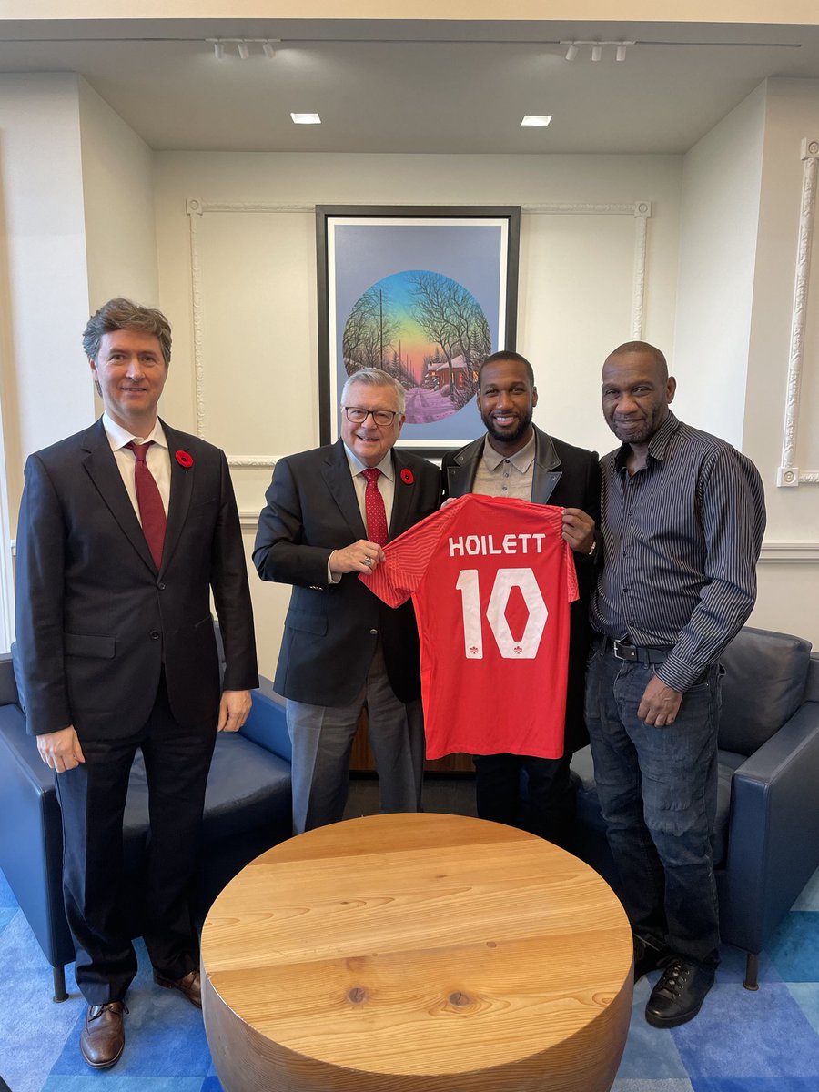 RalphGoodale's tweet photo. DHC Rob Fry and I were delighted to welcome ⁦@jnrhoilett⁩ and his dad to Canada House last week - just before he got called up to Canada’s squad for the ⁦@FIFAWorldCup⁩! Congratulations Junior! Good luck and let’s go make history 🇨🇦⚽️

#GoCanadaGo
#WeCAN. #CanMNT https://t.co/tbENhXJ5Qn