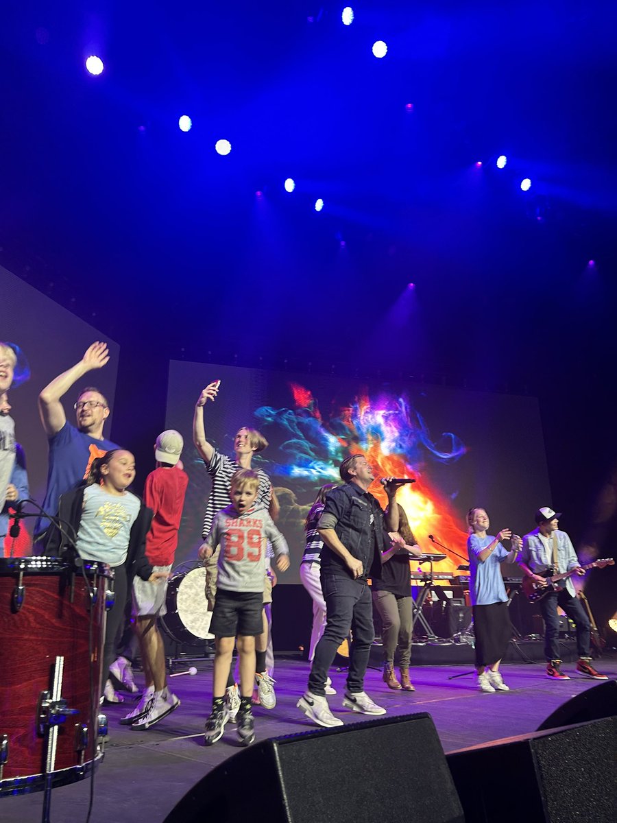 BGEA's tweet photo. A celebration is happening at the #GodLovesYouTour in Wellington, New Zealand, after many chose to follow Christ. Some youth and kids enjoyed joining @theafters onstage to joyfully dance and sing to God. https://t.co/QUBIr8aLER