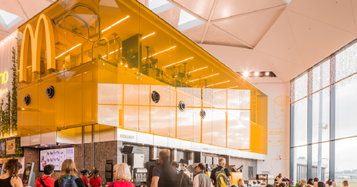 McDonaldsCorp's tweet photo. One of the coolest McDonald’s restaurants is located inside Sydney International Airport. The kitchen and crew are perched above the counter, where they prepare and bag orders before putting them on a conveyor belt to be delivered to travelers. Innovative and beautiful! https://t.co/X9KaqIYwsy