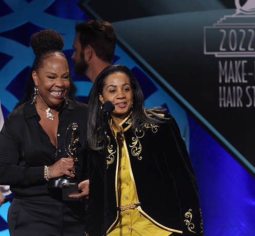 MUAHSawards's tweet photo. Carla Farmer and Stacey Morris @StaceyKutzLive accept the award for Best Contemporary Hairstyling for Coming 2 America (Not pictured are winners Louisa Anthony and Victor Paz). Incredible work transforming the cast into a wide array of characters. #MUAHSawards #local706 https://t.co/ql2aI9JsmK