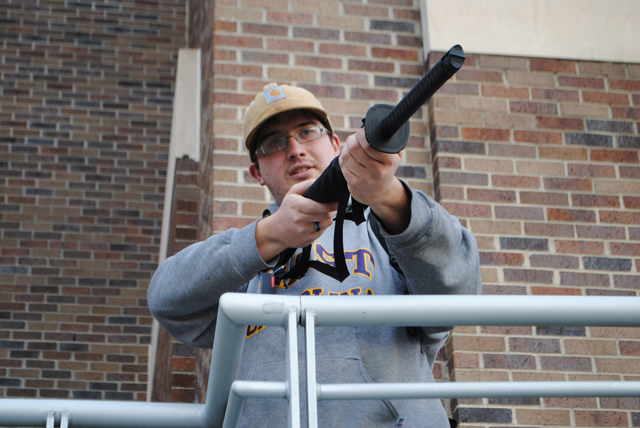 NES_Professor's tweet photo. Happy 11th Gunbrella-versary! Eleven years ago today ECU campus police spotted student Jimmy Callaway's umbrella protruding from his backpack via surveillance cams, mistook it for a rifle, and initiated a campus-wide lockdown. He later posed with the parasol that started it all. https://t.co/LFufgKIxBE