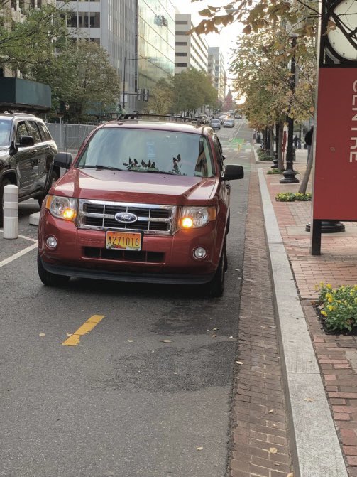 LaneSquattersDC's tweet photo. Driver seen parked illegally in the 20th St protected bike lane between L + M St NW this morning. @311DCgov #bikedc #safestreets #PSEPnow https://t.co/9degOMOBR0