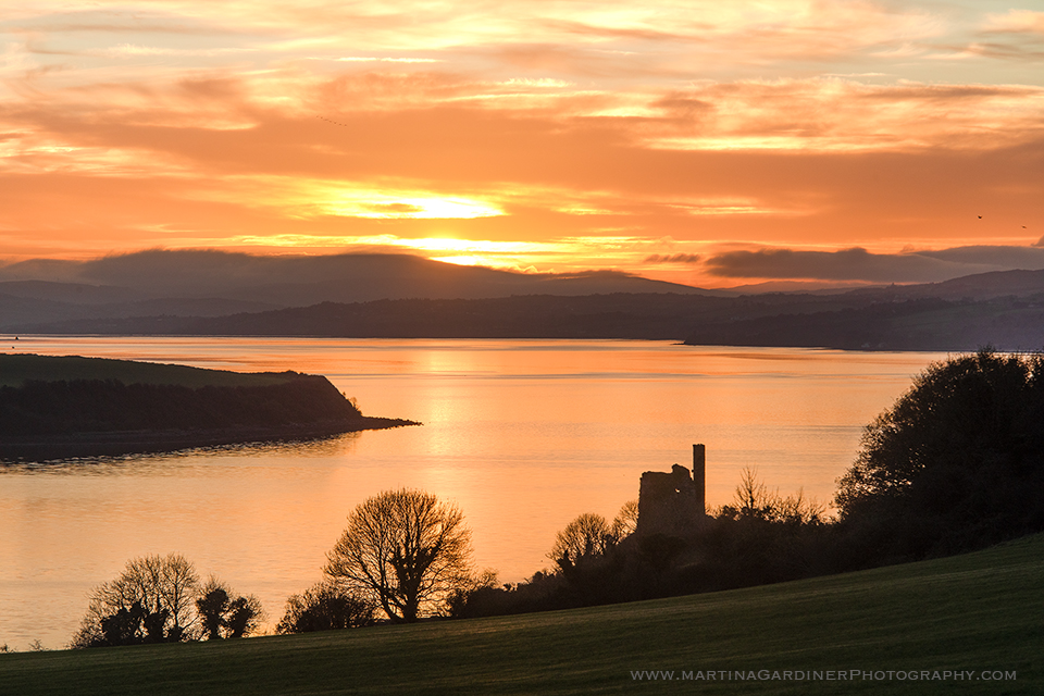 The view of Inch Castle and Lough Swilly this evening with some beautiful golden light and colour #Inchisland #Donegal
