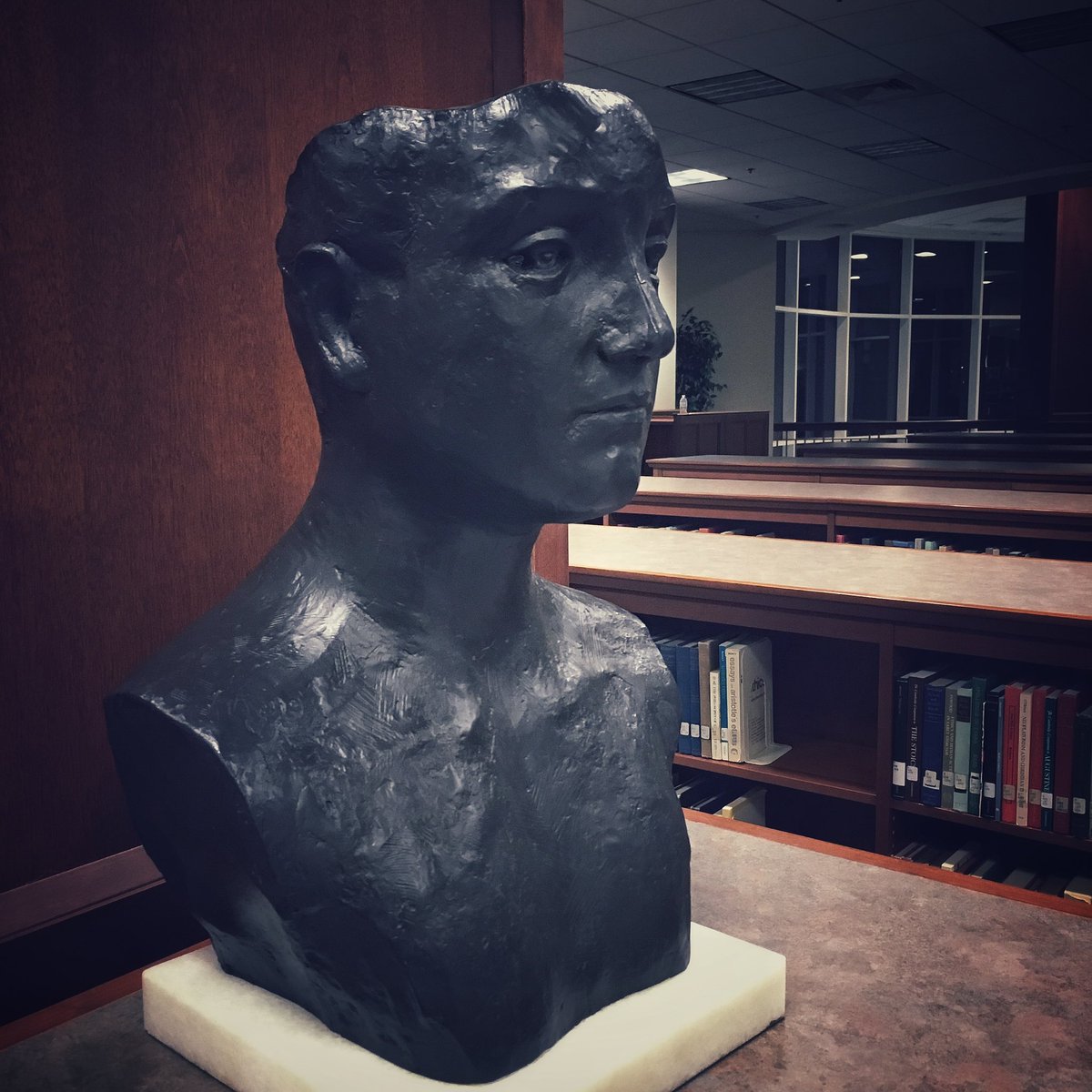 One of the art pieces you’ll find in the library is this bust in the religion section of the main collection. After closing, its silhouette can still be seen from Dunning Drive and looks just like a person sitting at one of the study tables by the top floor windows!