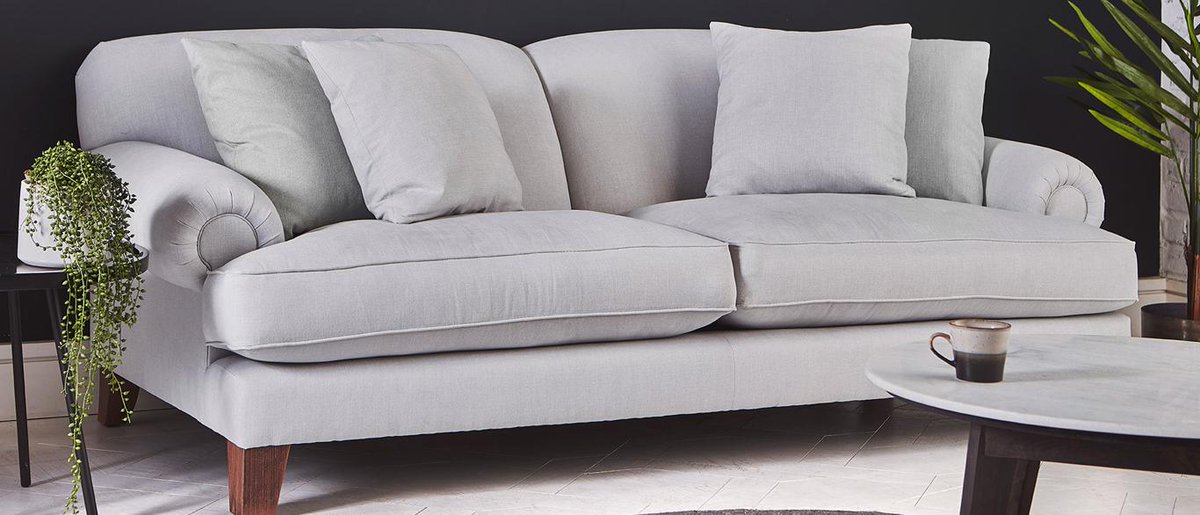 The Thatcham sofa has a classic, stylish design with a curved back, chunky feet, and rounded arms, as well as sumptuous seat cushions that provide a comfortable place to sink into and relax.