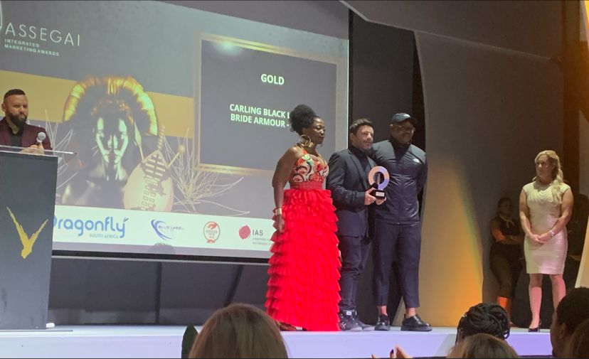 Victoria Grant presenting a Gold award to Ogilvy for their Carling Black Label - ride Armour at #AssegaiAwards2022