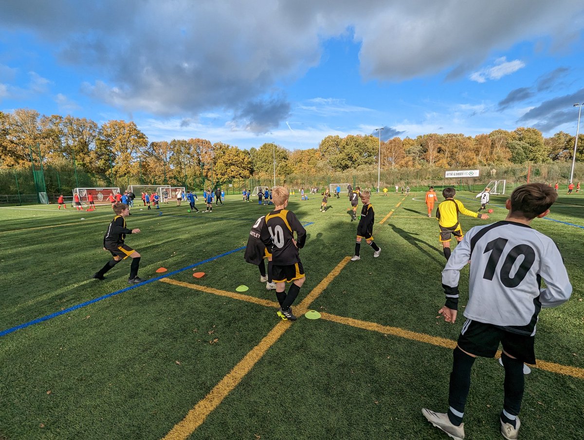 Year 5 and 6 boys enjoying a rain free afternoon at a football festival in the forest.
