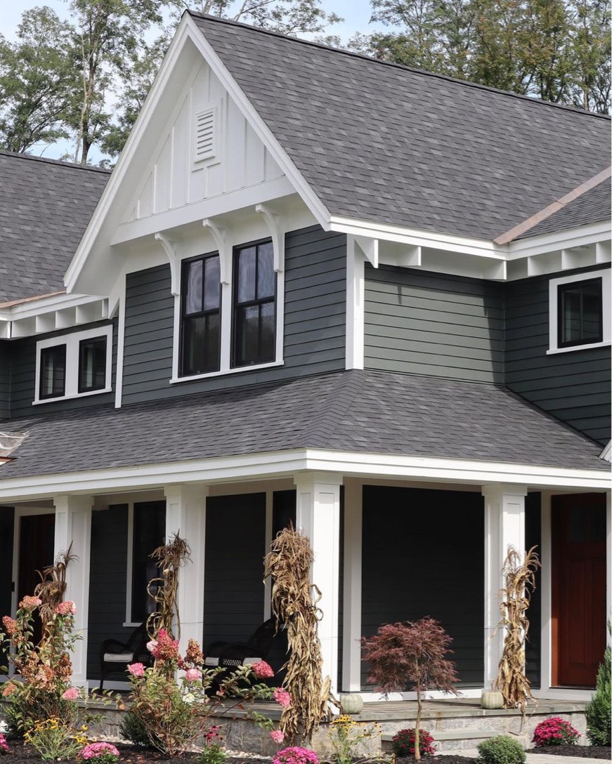 This two-tone home with black windows gives us all the fall feels.​

​We love the dramatic contrast of the white trim, charcoal siding and sleek black windows. Incredible work by Caruso Builders.