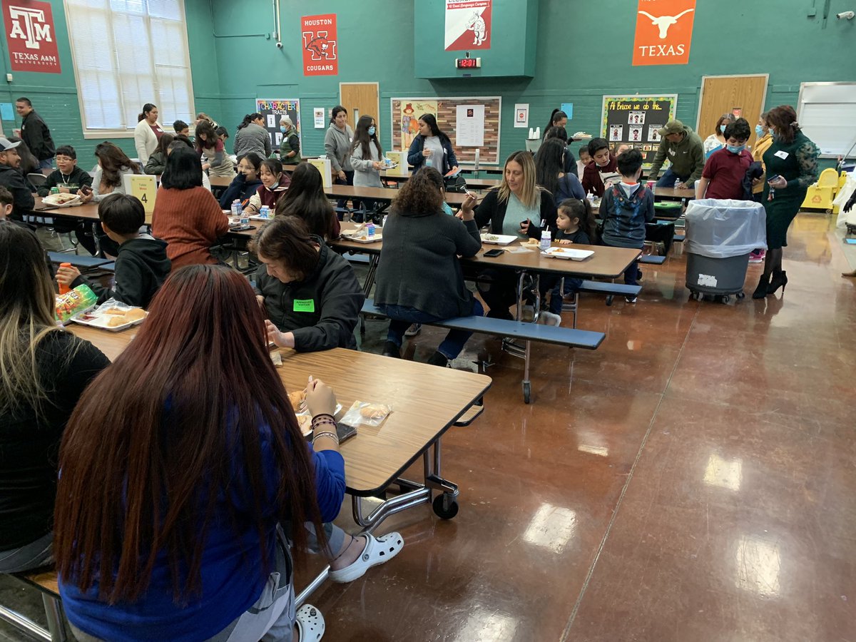 Students and families have lunch together to celebrate Thanksgiving.