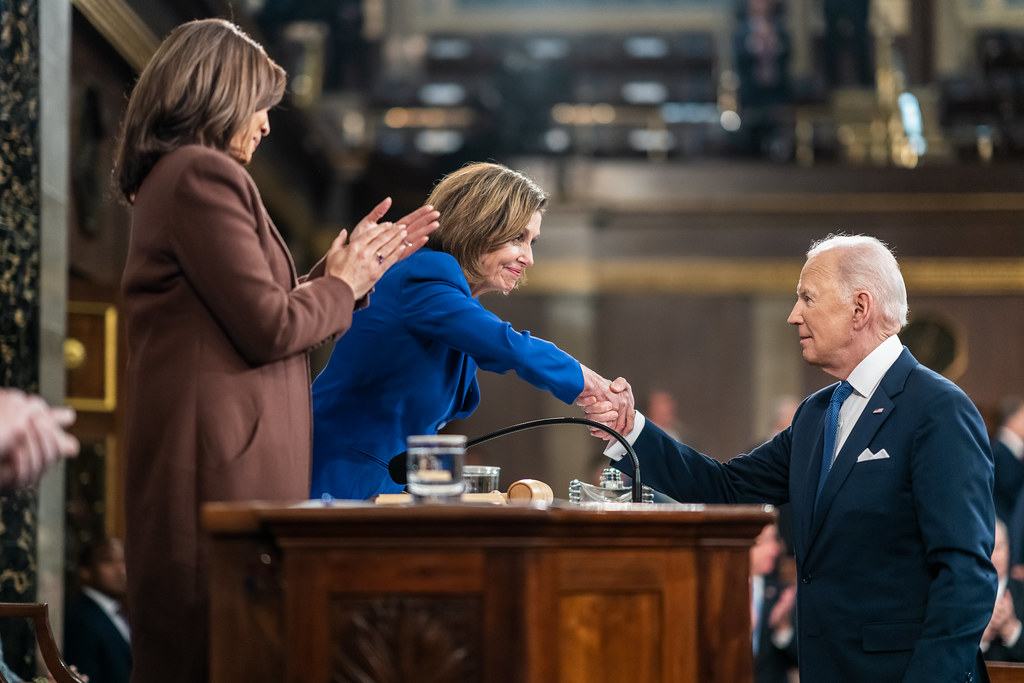 President Biden shakes hands with Congresswoman Nancy Pelosi.