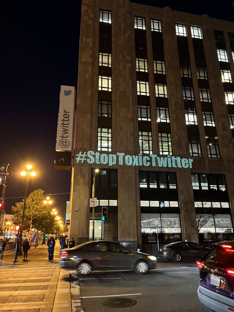 Gia_Vang's tweet image. Someone is projecting multiple messages onto Twitter headquarters building in SF from a neighboring building.