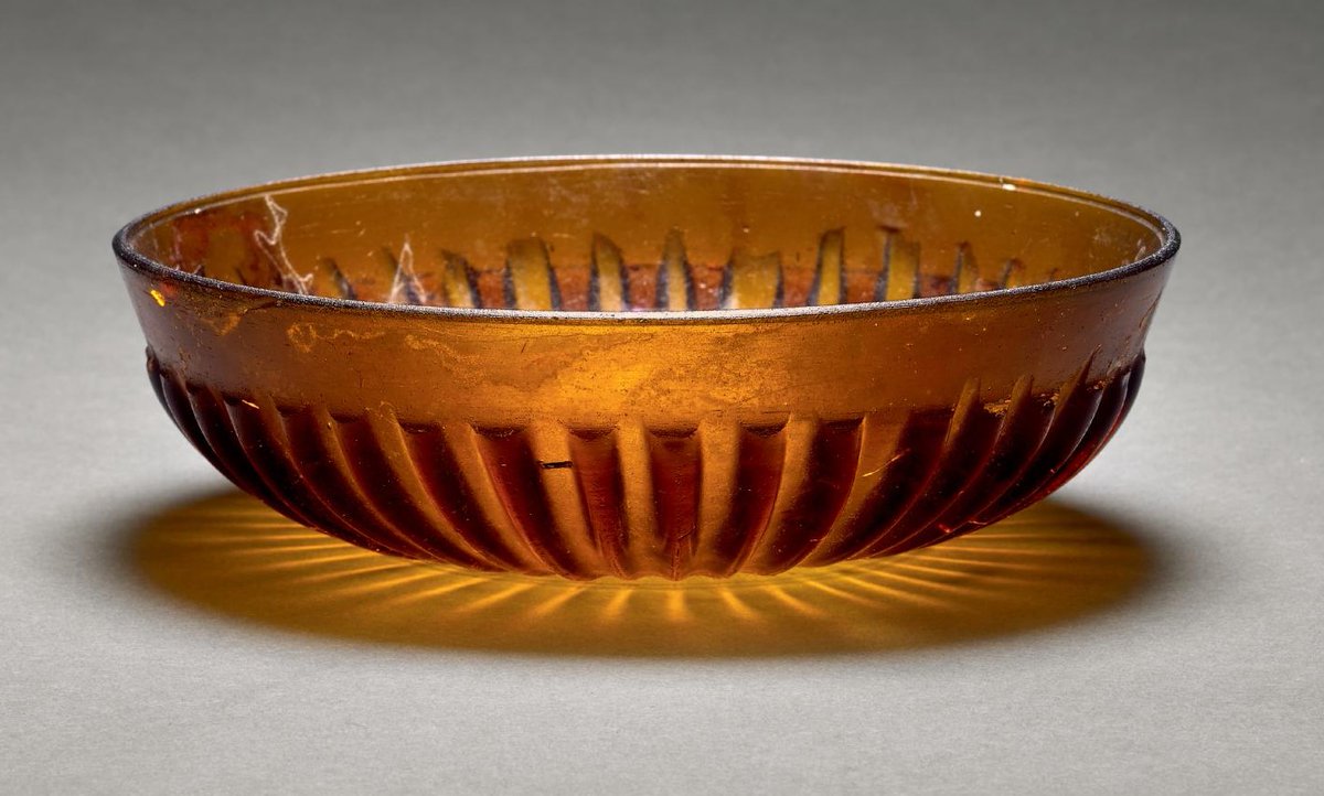 A gorgeous #Roman glass bowl, made from amber-coloured glass. It has survived in beautiful condition and despite being around 2000 years old, would probably not look out of place in a home today! #AncientGlass #RomanArchaeology (📷 Sotheby's)