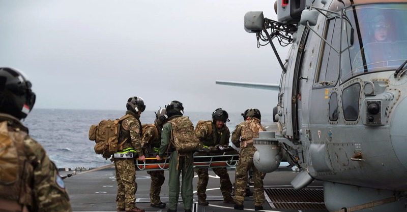 RoyalNavy's tweet photo. Naval medics test ‘air ambulance’ concept at sea for the first time by @HMSQNLZ and @HMS_Richmond, flying paramedics/doctors to the casualty, providing life-saving aid on the frigate then transferring the patient to the carrier's hospital. 🚁🚑