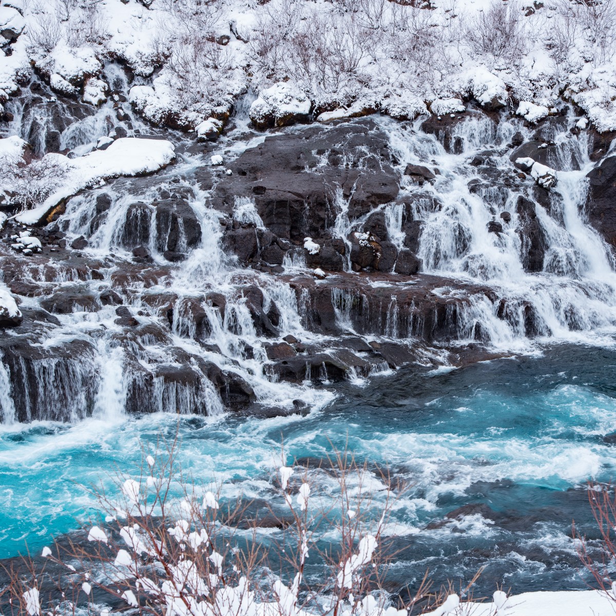 Hraunfossar is a perfect destination on your day trip from Reykjavík. This stunning waterfall can be translated directly to "Lava waterfall."