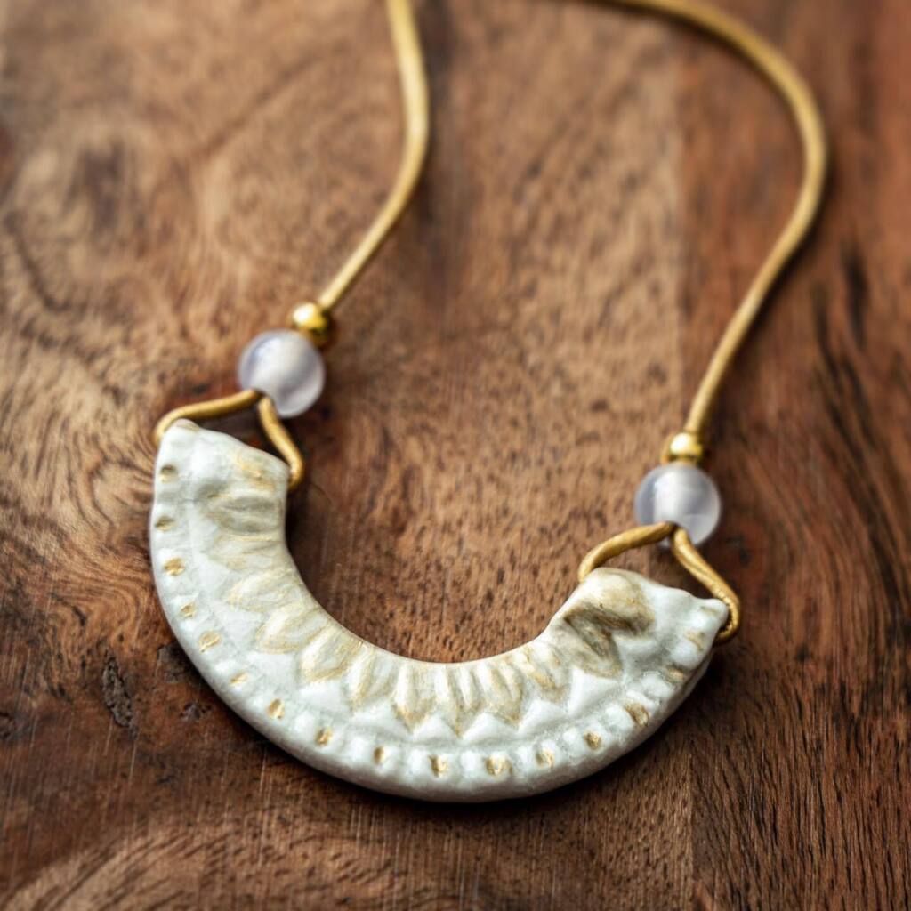 Ceramic necklace with leather cording and gold accents. 
—
#ceramicjewelry #potteryjewelry #handmadenecklace #necklace #texturedpottery #texturedceramics #tinyceramics #potteryofinstagram #ceramicpendant instagr.am/p/ClmOUmtvLxe/