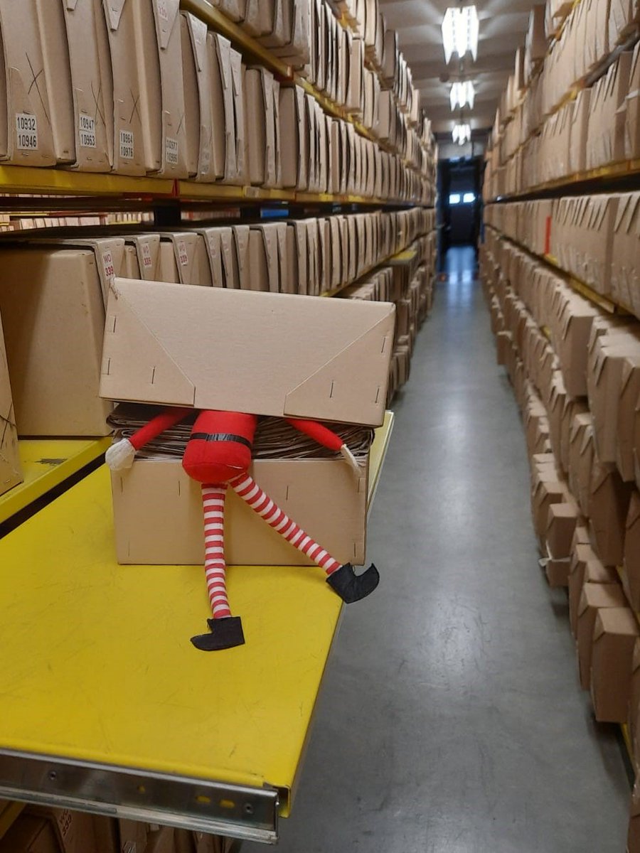 An unexpected visitor has been found rummaging through our archive boxes this morning #ElfOnAShelf